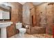 Bathroom features step in shower, brown tiling, and updated fixtures at 1440 Portola Ave, Deltona, FL 32738