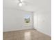 Bedroom boasts tile floors and a large window at 1440 Portola Ave, Deltona, FL 32738