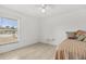 This bedroom features tile flooring, neutral walls, and a window view at 1440 Portola Ave, Deltona, FL 32738