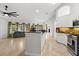 Modern kitchen island with views of the kitchen, the living room and outside light through windows at 1440 Portola Ave, Deltona, FL 32738