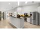 Modern kitchen featuring stainless steel appliances, sleek white cabinetry, and an island with bar seating at 1440 Portola Ave, Deltona, FL 32738