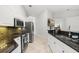 Well-lit kitchen boasts stainless steel appliances, granite counters, and an open design at 1440 Portola Ave, Deltona, FL 32738