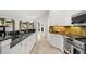 Charming kitchen with stainless appliances, tile backsplash, and sleek granite countertops at 1440 Portola Ave, Deltona, FL 32738