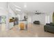 Open living space with tile flooring, skylights, kitchen island, and comfortable seating area at 1440 Portola Ave, Deltona, FL 32738