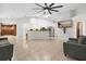 Bright living room featuring an open floor plan, tile flooring, and access to other rooms at 1440 Portola Ave, Deltona, FL 32738