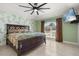 Comfortable main bedroom with decorative wall accents, ceiling fan, and natural light at 1440 Portola Ave, Deltona, FL 32738