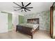 Inviting main bedroom offering a ceiling fan, wall accents, and neutral tile flooring at 1440 Portola Ave, Deltona, FL 32738