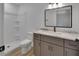 Modern bathroom featuring gray vanity with marble countertop, framed mirror, and shower with white tile at 1450 Benham Ave, Orange City, FL 32763