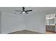 Bedroom featuring wood-look floors, closet, ceiling fan with light fixture and an en-suite bathroom at 1450 Benham Ave, Orange City, FL 32763