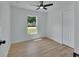 Bedroom featuring wood-look floors, a closet and window with neighborhood view at 1450 Benham Ave, Orange City, FL 32763