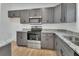 Modern kitchen featuring stainless steel appliances, granite countertops, and ample cabinet space at 1450 Benham Ave, Orange City, FL 32763