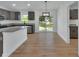 Modern kitchen with granite countertops and stainless steel appliances, and sliding glass doors at 1450 Benham Ave, Orange City, FL 32763