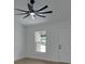 Bright living room featuring light-colored walls, wood floors and a stylish ceiling fan with light fixture at 1450 Benham Ave, Orange City, FL 32763