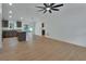 Open-concept living space featuring wood-look floors, flowing into the kitchen and dining areas at 1450 Benham Ave, Orange City, FL 32763
