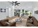 Open-concept living space featuring wood-look floors, stylish furnishings, and ample natural light at 1450 Benham Ave, Orange City, FL 32763