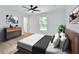 Bright bedroom with a ceiling fan, window views, and modern furnishings at 1450 Benham Ave, Orange City, FL 32763