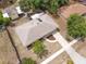 Aerial view of the home with a well-maintained roof, manicured lawn, and convenient driveway access at 1511 Jack St, Tavares, FL 32778