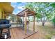 Back yard featuring the gazebo, outdoor grill, and screened porch of home at 1511 Jack St, Tavares, FL 32778