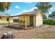 Cozy backyard shed with a wooden deck and two chairs, offering a private outdoor retreat at 1511 Jack St, Tavares, FL 32778