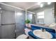 Bathroom featuring a large shower, grab bars, blue counters, and a decorative plant at 1511 Jack St, Tavares, FL 32778