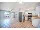 Open-concept layout featuring the kitchen with stainless steel appliances and an adjacent living area at 1511 Jack St, Tavares, FL 32778