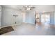 Spacious living room featuring tile flooring and neutral paint, adjacent to the kitchen and dining areas at 1511 Jack St, Tavares, FL 32778