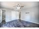 Spacious main bedroom featuring a ceiling fan, wood-look flooring, and en suite bathroom access at 1511 Jack St, Tavares, FL 32778