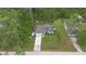 An aerial view of a home with a long drive way and green landscape at 1550 11Th Ave, Deland, FL 32724