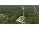 An aerial view showing the property's location within a green, wooded neighborhood at 1550 11Th Ave, Deland, FL 32724