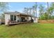 Beautiful backyard with a patio, outdoor seating, and a well-maintained lawn at 1550 11Th Ave, Deland, FL 32724