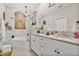 Stylish bathroom featuring a double vanity with granite counters and a soaking tub at 1550 11Th Ave, Deland, FL 32724