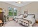 Cozy bedroom with twin beds, a large window, and neutral decor at 1550 11Th Ave, Deland, FL 32724