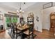 Elegant dining area with hardwood floors, stylish furnishings, and a view of the adjacent kitchen and backyard at 1550 11Th Ave, Deland, FL 32724