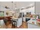 Bright and open kitchen with an island, stainless steel appliances, and a seamless flow into the dining and living areas at 1550 11Th Ave, Deland, FL 32724