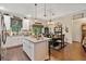 Modern kitchen and dining area featuring a central island, granite countertops, and stainless steel appliances at 1550 11Th Ave, Deland, FL 32724