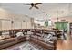 Spacious living area with hardwood floors, a comfortable sectional sofa, and an open view into the kitchen and dining area at 1550 11Th Ave, Deland, FL 32724