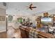 Open-concept living room showcasing hardwood floors, a cozy fireplace, and an adjacent kitchen and dining area at 1550 11Th Ave, Deland, FL 32724