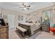 Serene main bedroom with neutral tones, hardwood floors, and a comfortable seating area for relaxation at 1550 11Th Ave, Deland, FL 32724