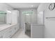 Modern bathroom with white cabinets, granite countertop, glass shower, and marble flooring at 1601 Toledo Ave, Deltona, FL 32725