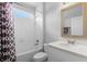 Well-lit bathroom with white subway tiles, shower curtain, and granite vanity at 1601 Toledo Ave, Deltona, FL 32725