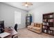 Study bedroom with a desk, computer, love seat, and a wall of books at 1601 Toledo Ave, Deltona, FL 32725