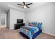 Comfortable bedroom with a ceiling fan, dresser, carpet, and a view of the bathroom at 1601 Toledo Ave, Deltona, FL 32725