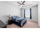 Cozy bedroom featuring a bed, ceiling fan, window with curtains, carpet, and a side table at 1601 Toledo Ave, Deltona, FL 32725