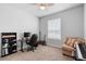 Spacious bedroom with a desk, guitar, love seat, and lots of natural light at 1601 Toledo Ave, Deltona, FL 32725