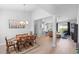 Spacious dining area featuring a wood table, chandelier lighting, and seamless access to the living room at 1601 Toledo Ave, Deltona, FL 32725