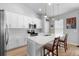 Bright kitchen featuring white cabinets, stainless steel appliances, and a large island with seating at 1601 Toledo Ave, Deltona, FL 32725