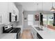 Modern kitchen featuring white cabinets, stainless steel appliances, and island with an undermount sink at 1601 Toledo Ave, Deltona, FL 32725