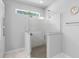 Modern walk-in shower with granite base, marble walls, and a window for natural light at 1601 Toledo Ave, Deltona, FL 32725
