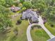 A high angle view of a suburban home featuring a circular driveway and landscaped front yard at 1661 Timber Hills Dr, Deland, FL 32724