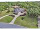 Aerial view of the home showing meticulous landscaping, a circular driveway, and mature trees at 1661 Timber Hills Dr, Deland, FL 32724